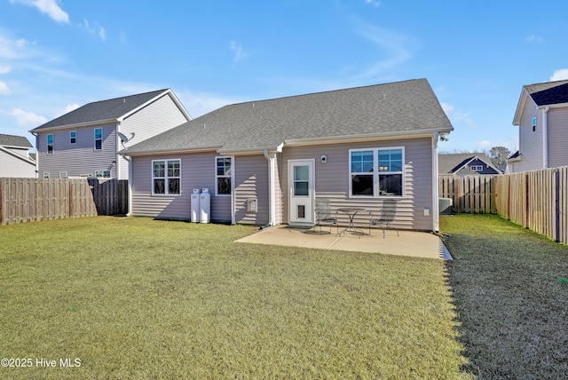 back of house featuring cooling unit, a lawn, and a patio area