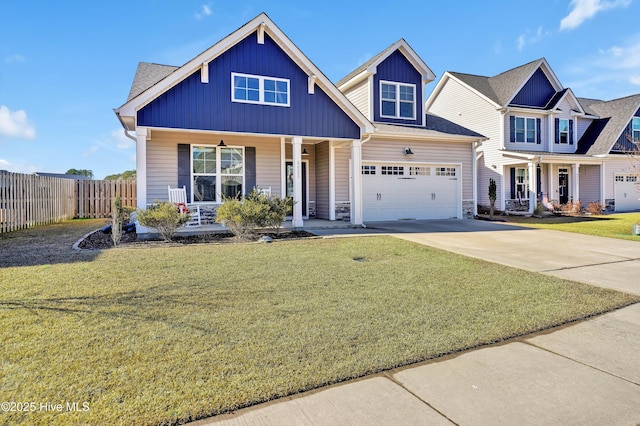 view of front of property with a porch, a garage, and a front yard