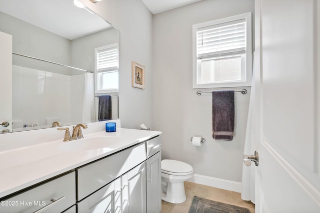 bathroom with vanity, curtained shower, and toilet