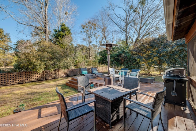 wooden deck featuring outdoor lounge area, a yard, and grilling area