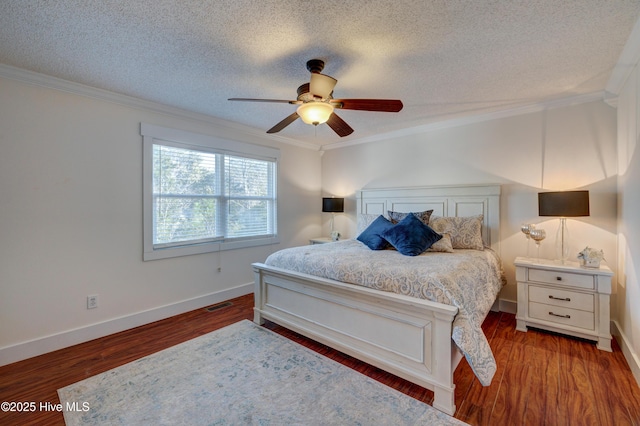 bedroom featuring wood-type flooring, ornamental molding, and a textured ceiling