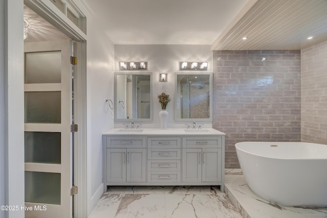 bathroom with vanity, separate shower and tub, and tile walls