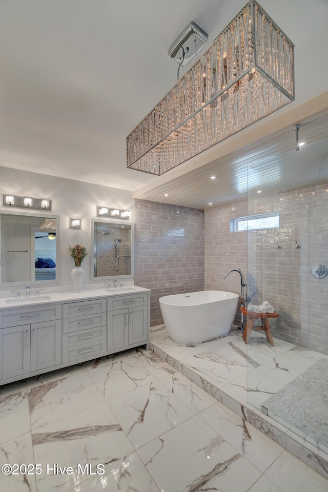 bathroom with vanity and separate shower and tub