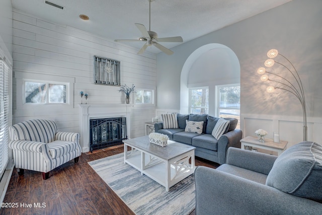 living room featuring dark hardwood / wood-style flooring and ceiling fan