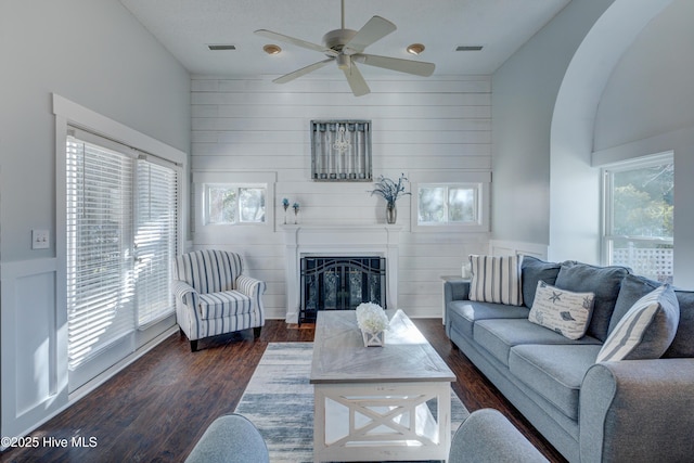 living room with ceiling fan and dark hardwood / wood-style flooring