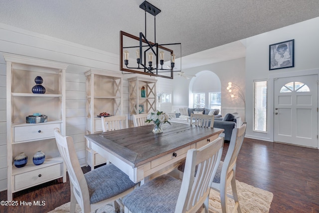 dining room with an inviting chandelier, dark hardwood / wood-style floors, and a textured ceiling