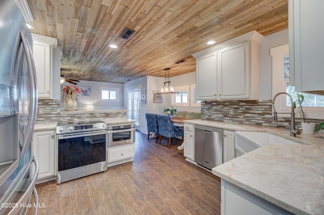 kitchen featuring white cabinetry, sink, pendant lighting, and appliances with stainless steel finishes