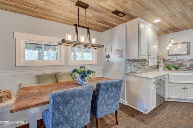 dining room with an inviting chandelier, sink, wood ceiling, and dark hardwood / wood-style floors