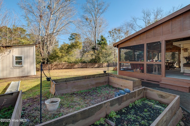 view of yard featuring a sunroom and a shed