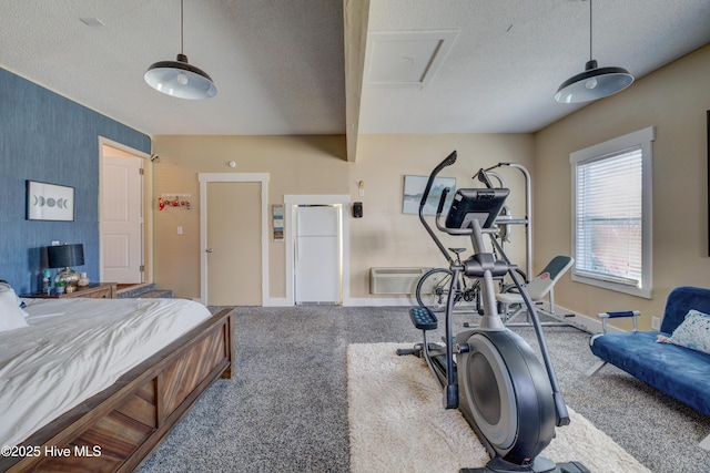 bedroom with carpet floors, a textured ceiling, and white fridge