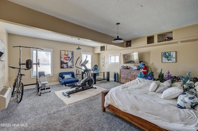 carpeted bedroom featuring multiple windows and a textured ceiling