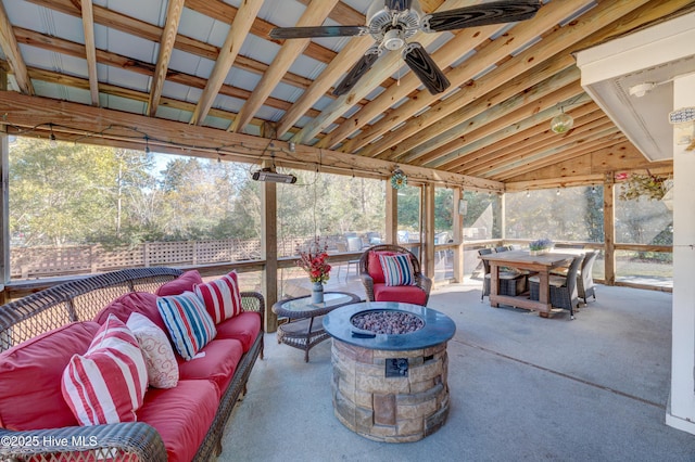 view of patio with an outdoor living space with a fire pit and ceiling fan