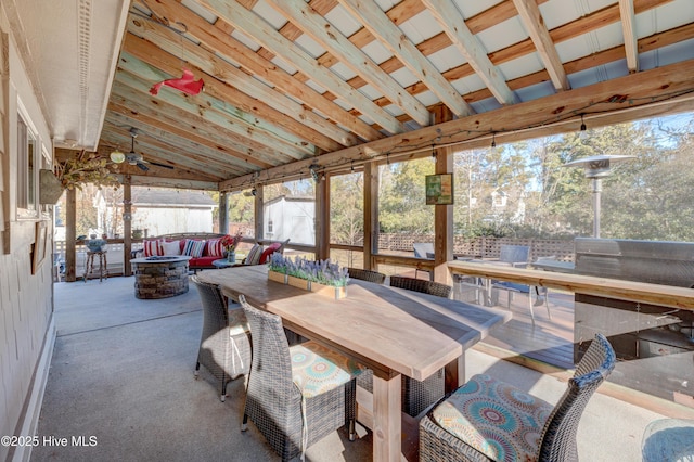 sunroom featuring ceiling fan and lofted ceiling