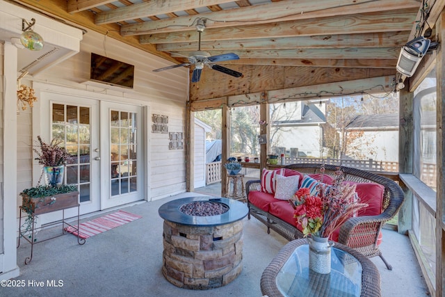 sunroom featuring ceiling fan and french doors