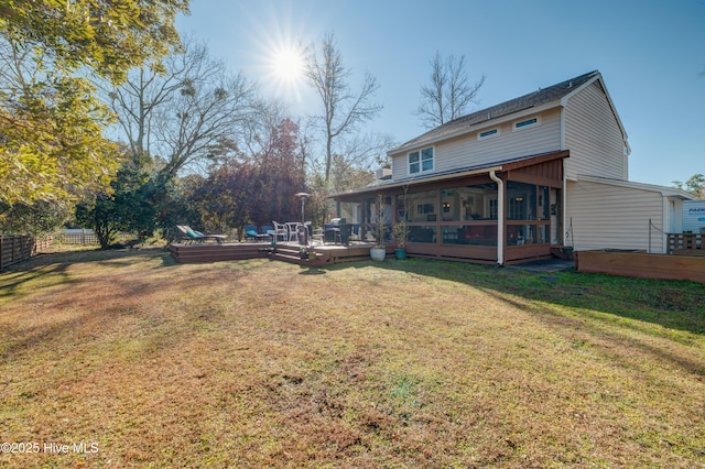 view of yard featuring a wooden deck and a sunroom