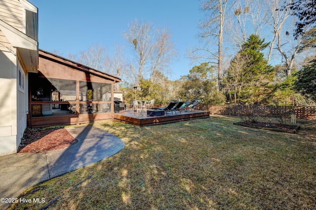 view of yard featuring a sunroom and a deck