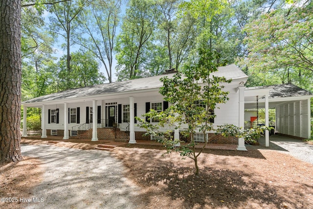 view of front of house featuring a carport and a porch