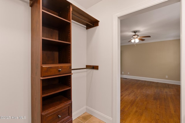 spacious closet with hardwood / wood-style floors and ceiling fan