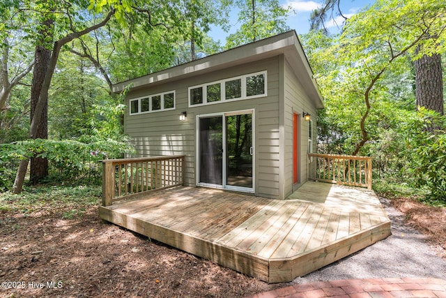 rear view of property featuring a wooden deck