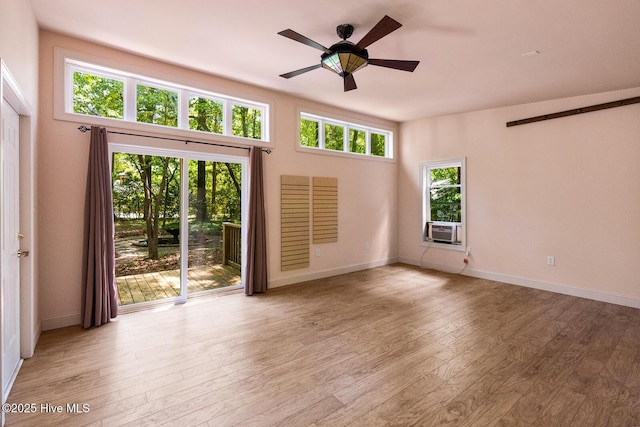 interior space featuring cooling unit, ceiling fan, and light hardwood / wood-style flooring