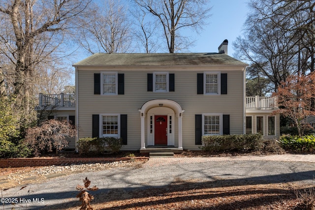 colonial-style house with a balcony