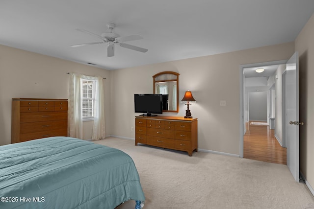 bedroom with light colored carpet and ceiling fan