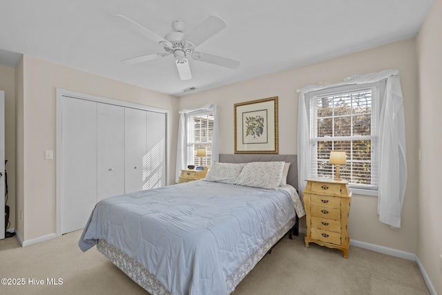 carpeted bedroom featuring ceiling fan and a closet