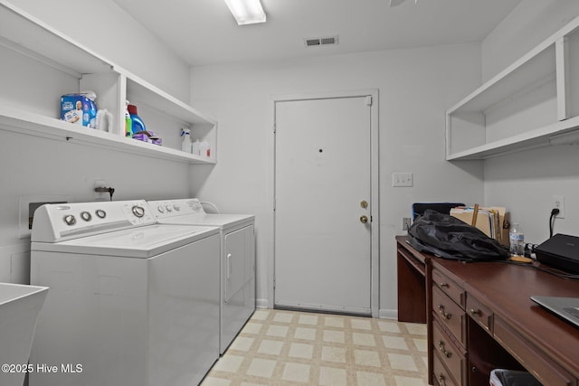 laundry area featuring washing machine and dryer and sink