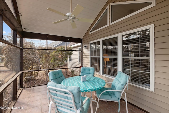 sunroom featuring ceiling fan, lofted ceiling, and a wealth of natural light