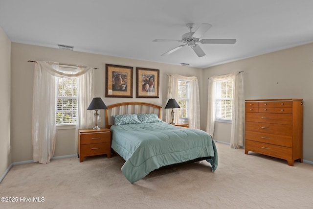 carpeted bedroom featuring multiple windows and ceiling fan