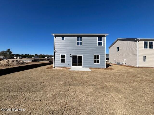 rear view of property featuring a patio area and a lawn