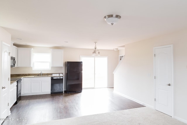 kitchen with decorative light fixtures, white cabinetry, sink, black appliances, and plenty of natural light