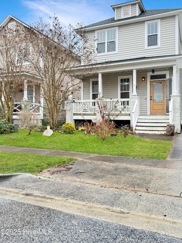 view of front of house with covered porch and a front lawn