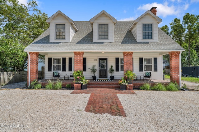 cape cod-style house featuring a porch