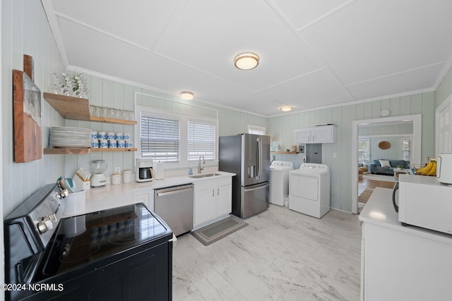 kitchen featuring sink, crown molding, white cabinetry, stainless steel appliances, and separate washer and dryer