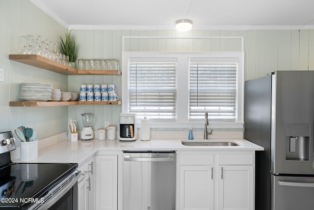 kitchen featuring white cabinetry, ornamental molding, appliances with stainless steel finishes, and sink