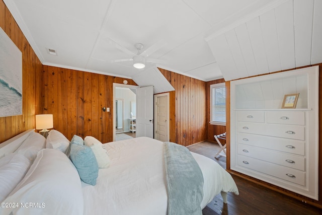 bedroom featuring hardwood / wood-style flooring, ceiling fan, wooden walls, and crown molding