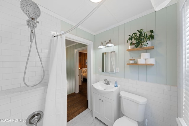 bathroom featuring vanity, curtained shower, ornamental molding, and toilet