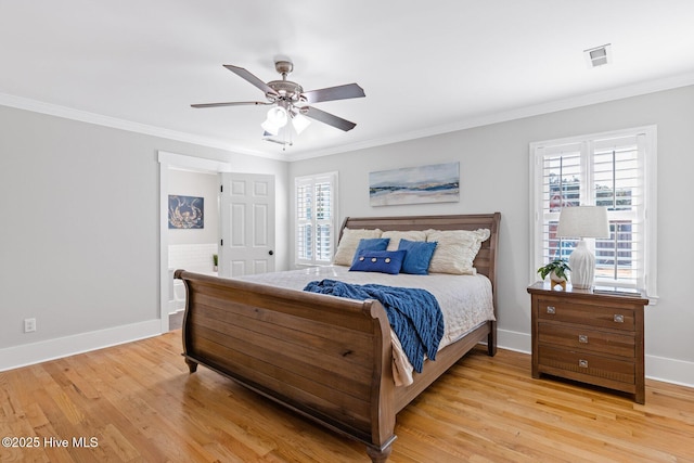 bedroom with multiple windows, crown molding, and light wood-type flooring