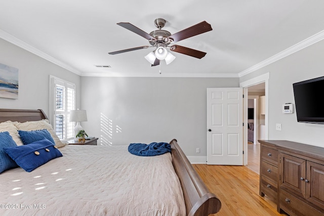 bedroom with crown molding, ceiling fan, and light wood-type flooring