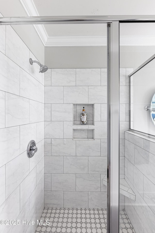 bathroom featuring an enclosed shower and crown molding