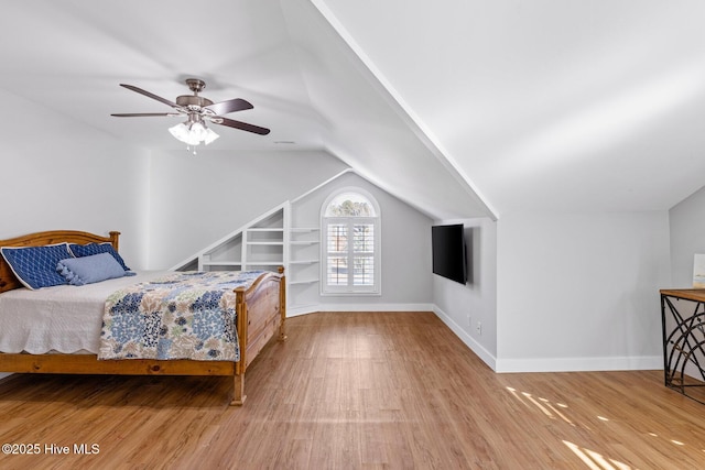 bedroom featuring wood-type flooring, ceiling fan, and vaulted ceiling