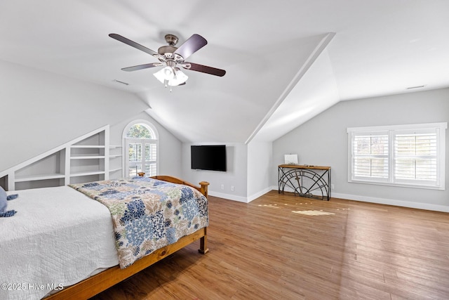 bedroom with lofted ceiling, hardwood / wood-style floors, and ceiling fan