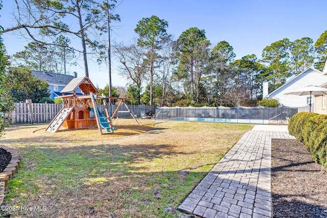 view of yard featuring a pool and a playground