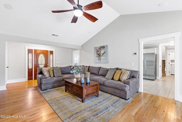 living room featuring high vaulted ceiling, ceiling fan, and light wood-type flooring