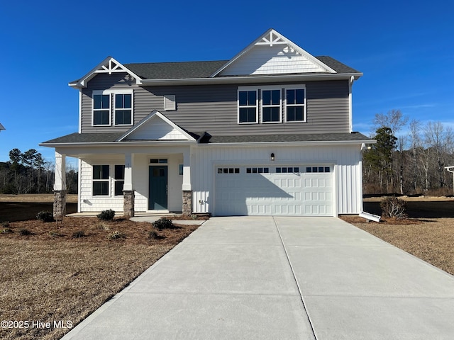 view of front of property with a garage and covered porch