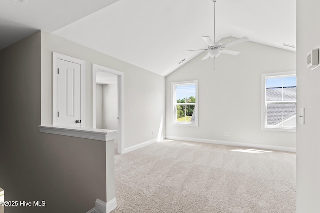 spare room with ceiling fan, lofted ceiling, and carpet flooring