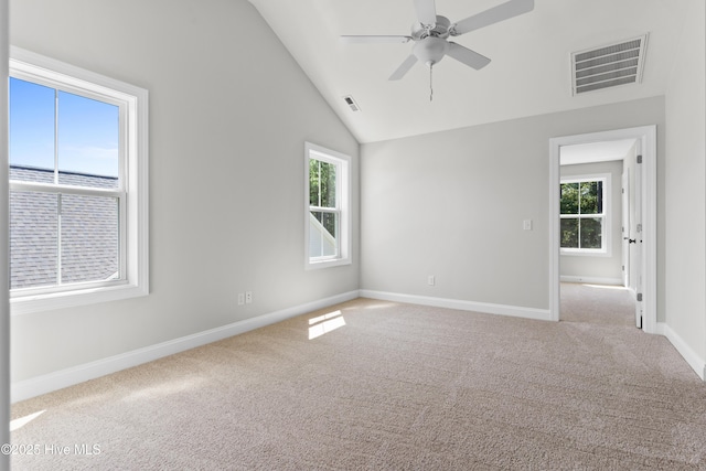 carpeted spare room featuring ceiling fan and lofted ceiling