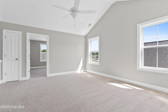 carpeted empty room with lofted ceiling and ceiling fan