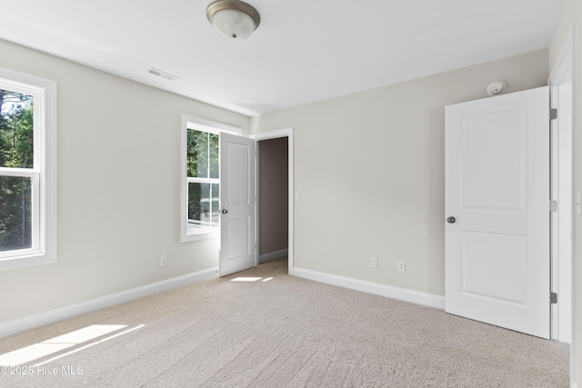 carpeted empty room featuring a healthy amount of sunlight